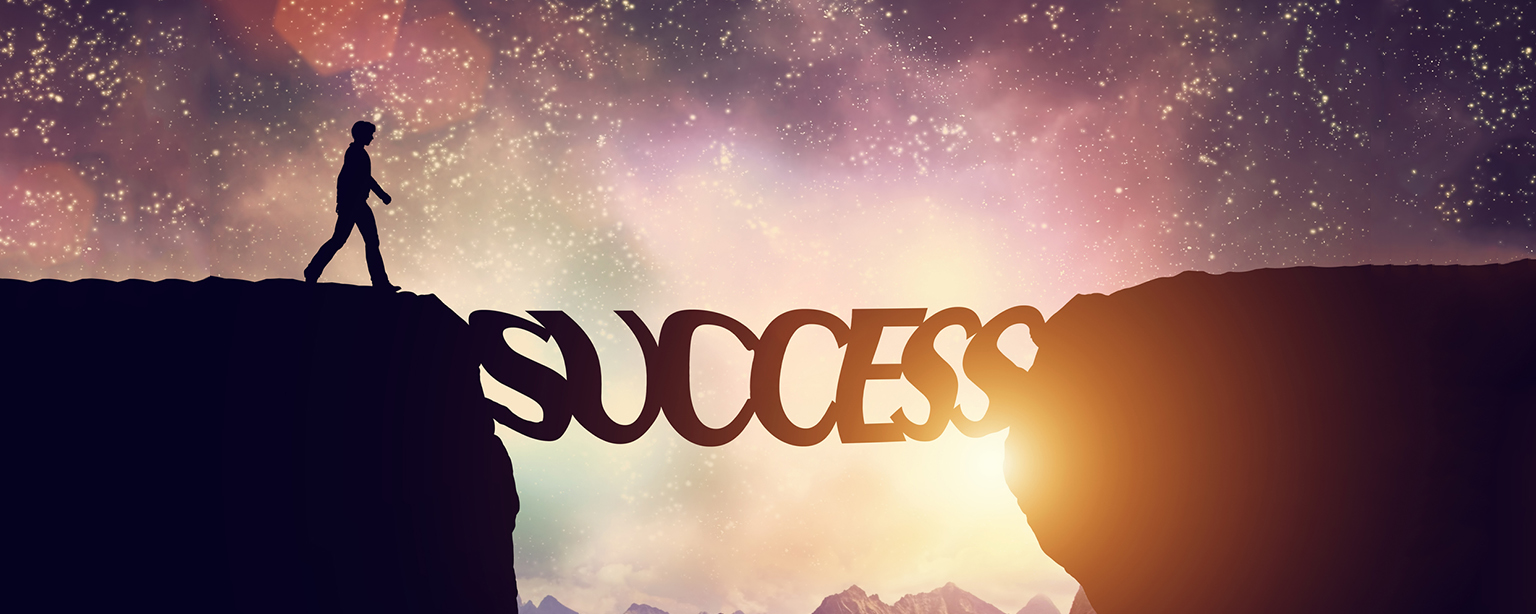 A silhouette crosses the bridge of "Success" under a starry sky.