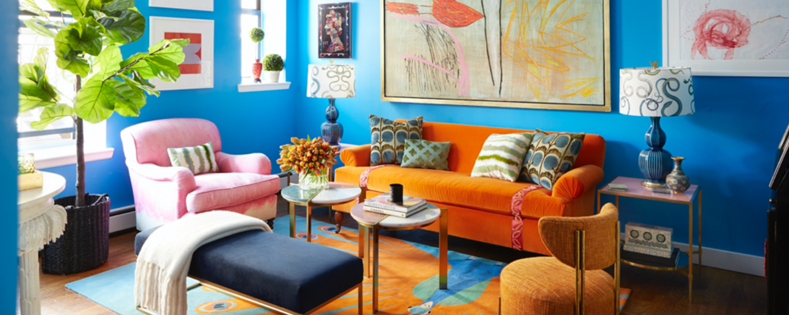 Vibrant living room with blue walls, orange sofa.