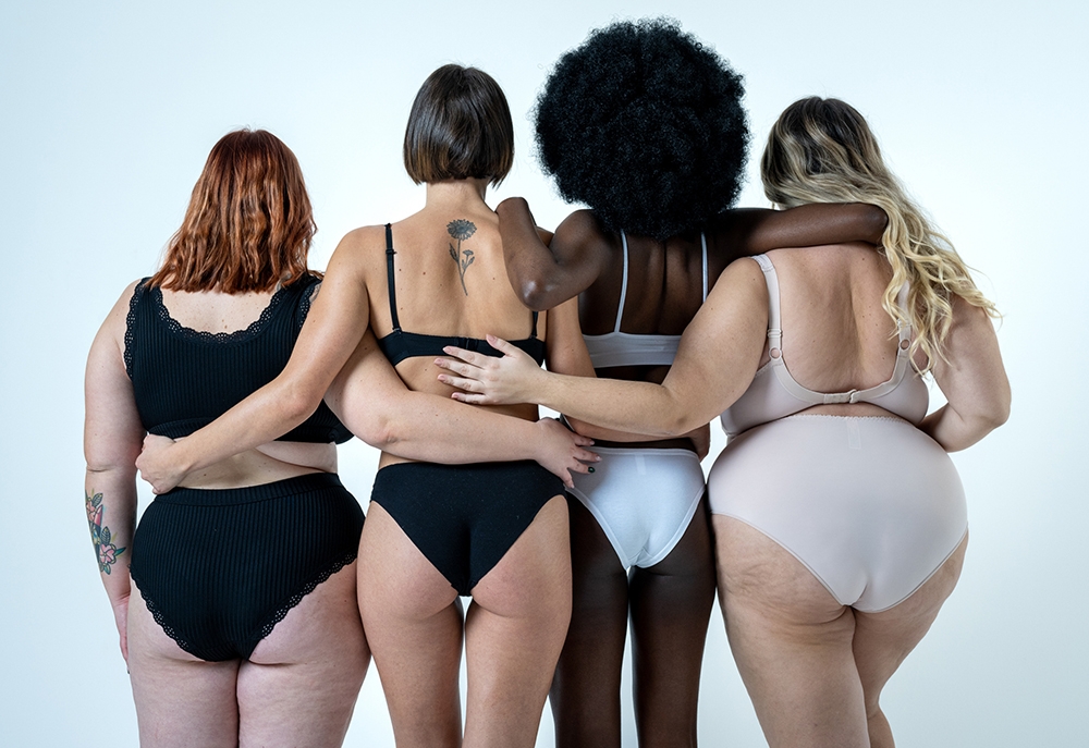 Diverse group of women in underwear, backs facing.