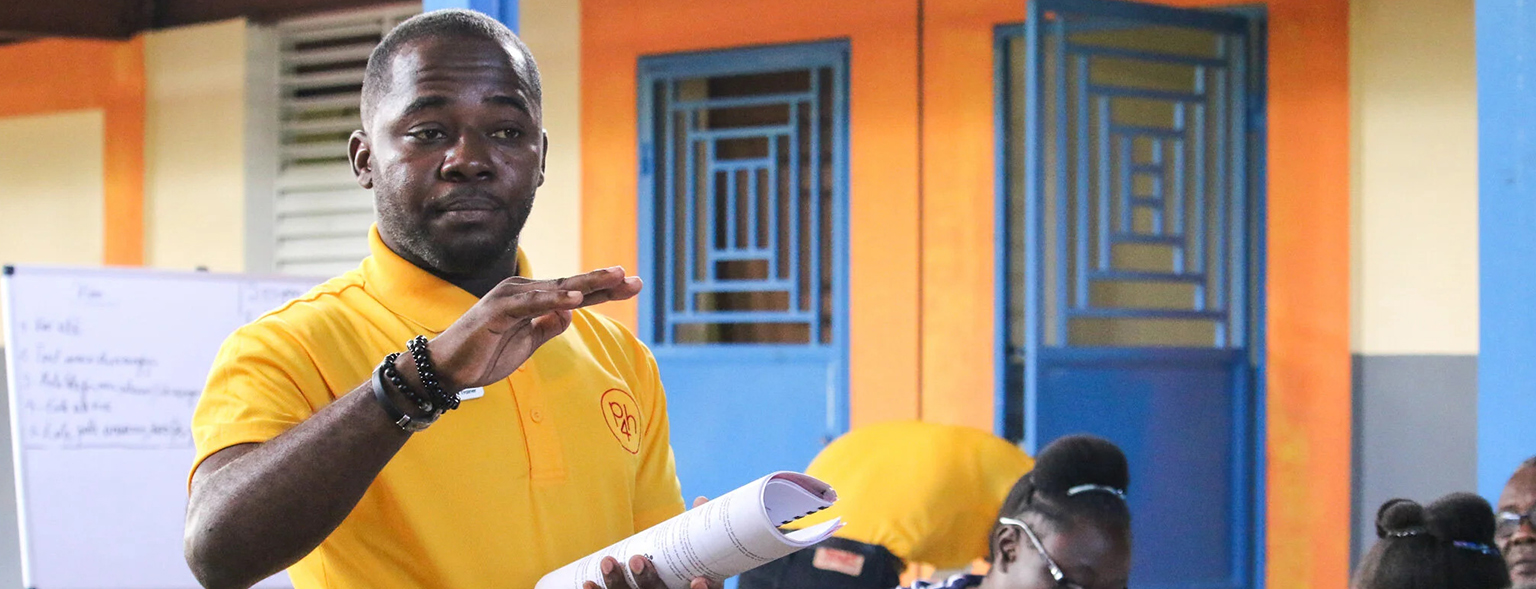 Haitian teacher guiding classroom learning