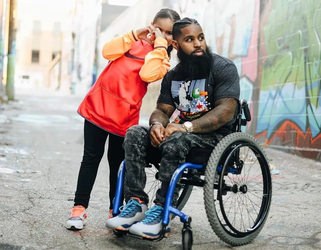 Child and man in wheelchair.