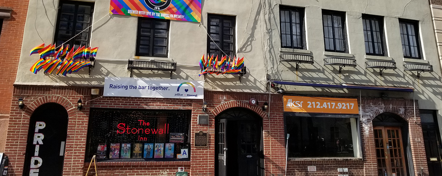 A banner and flags on The Stonewall Inn.