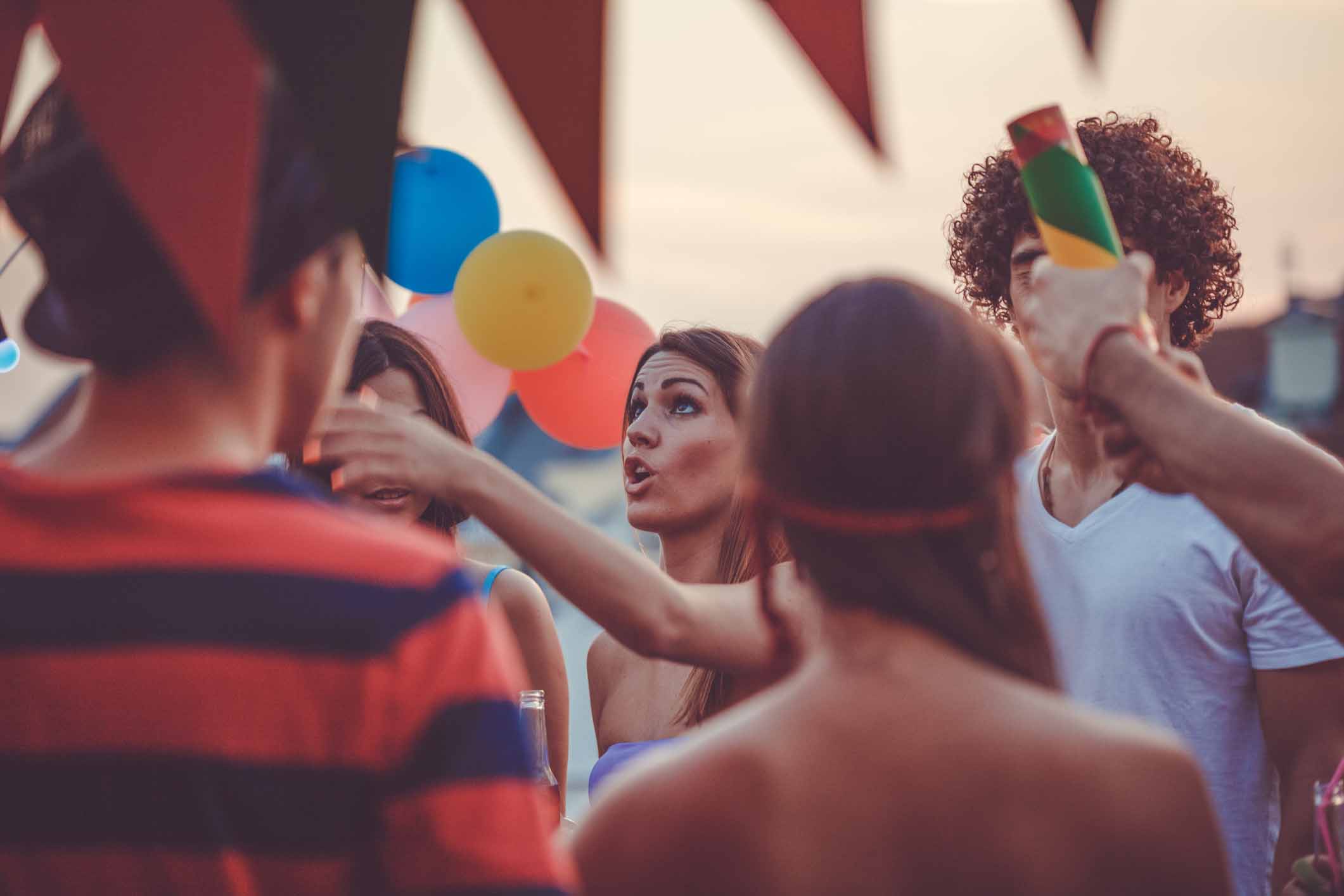 Friends talking and celebrating at an outdoor party.