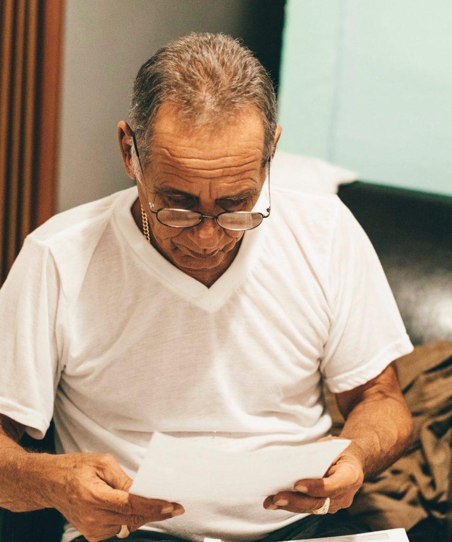 Elderly man reading heartfelt letter