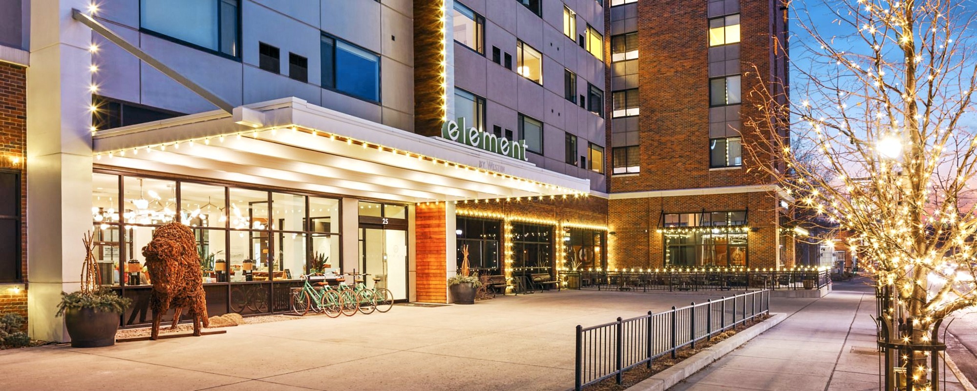 Modern hotel entrance illuminated at dusk