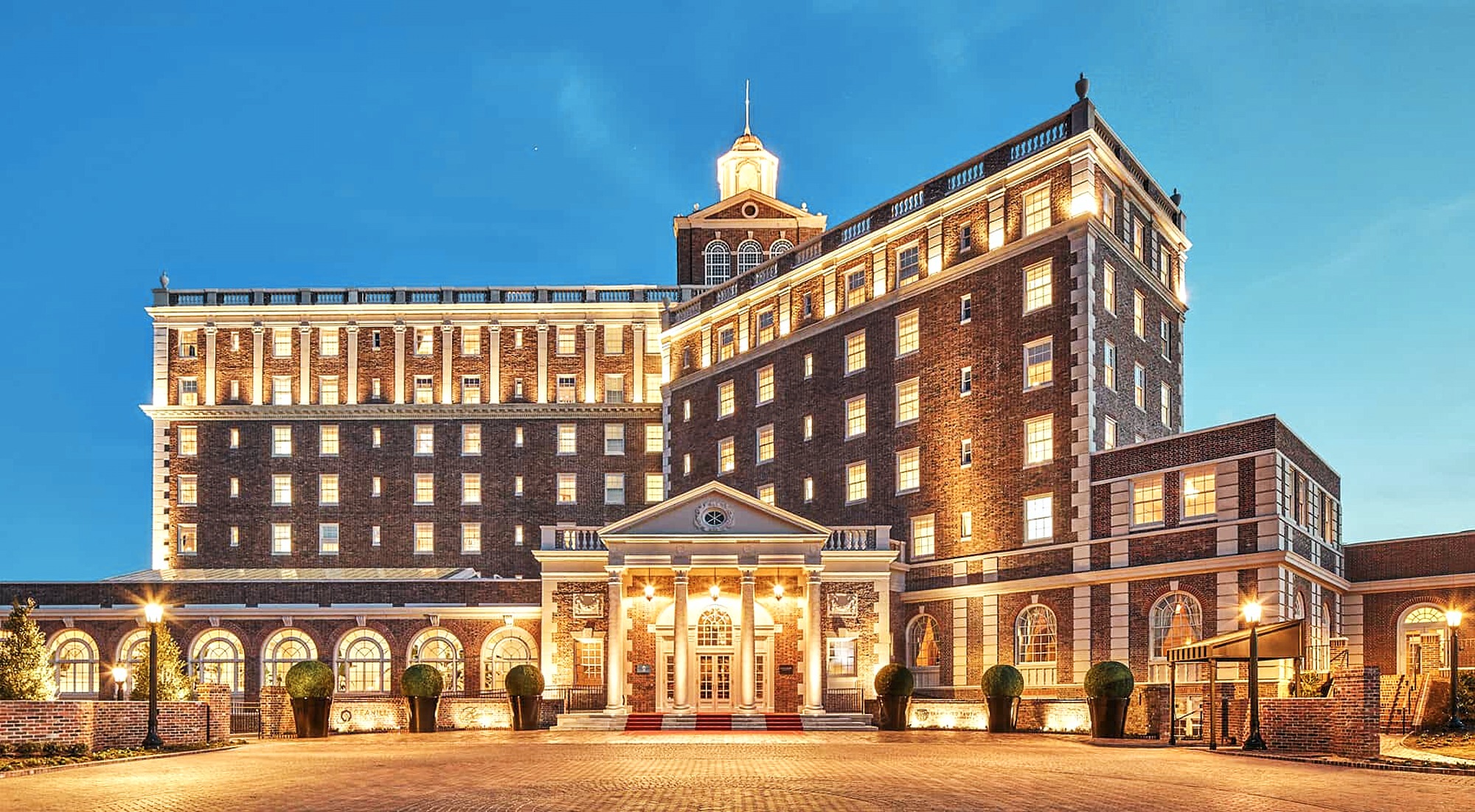 Elegant Cavalier Hotel exterior lit at night