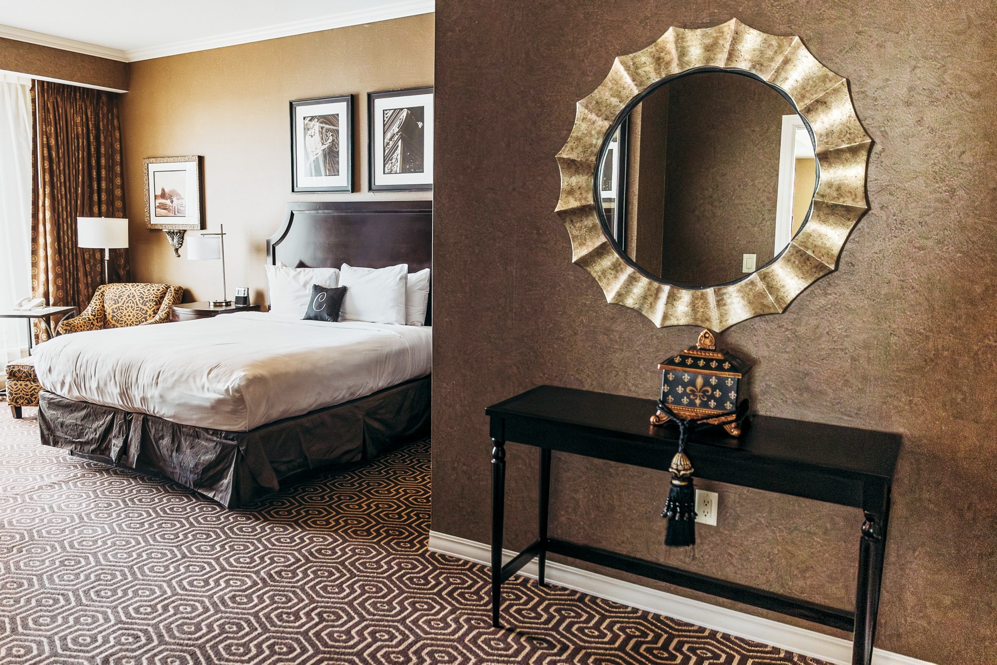 Upscale hotel bedroom with mirror above headboard