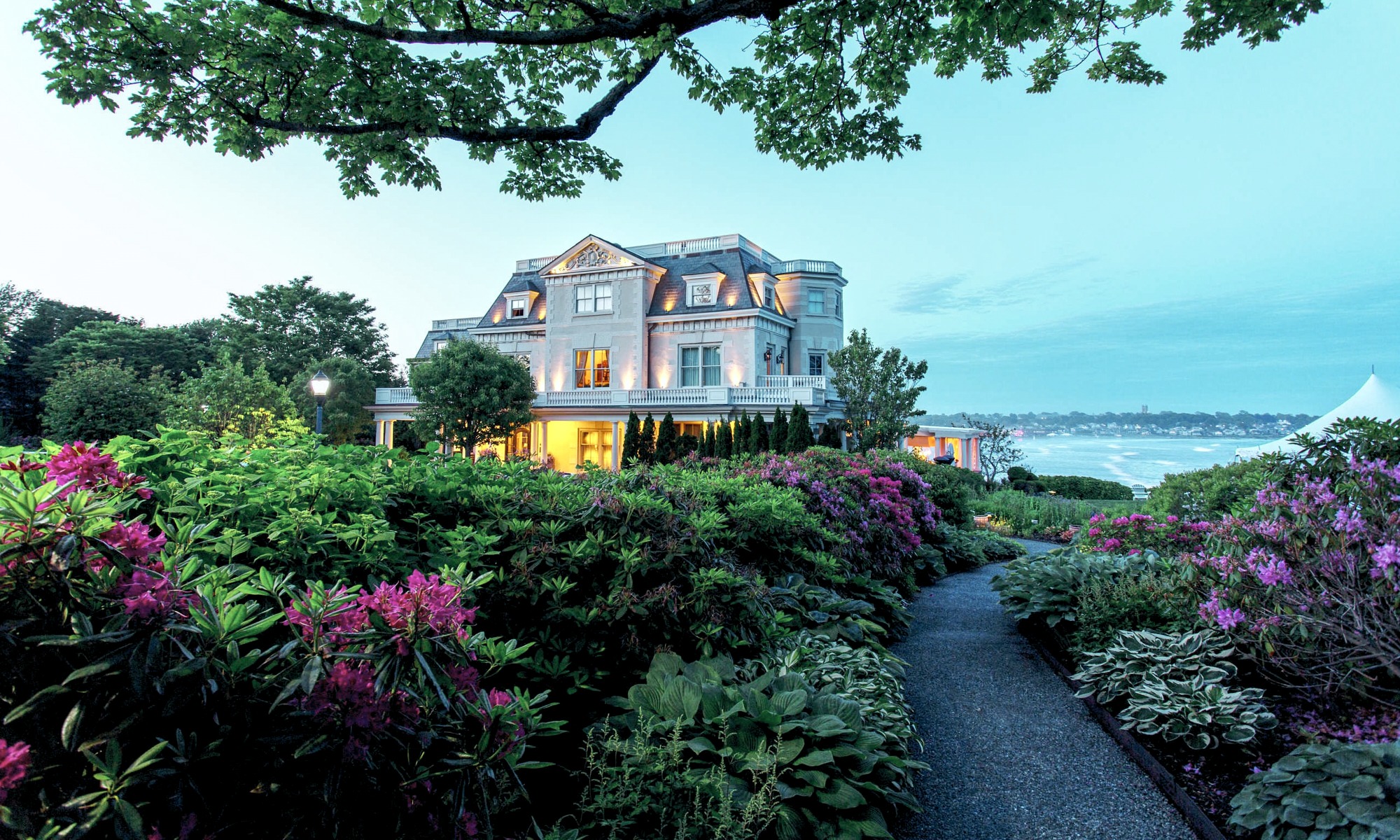 Manor-style hotel building surrounded by lush gardens