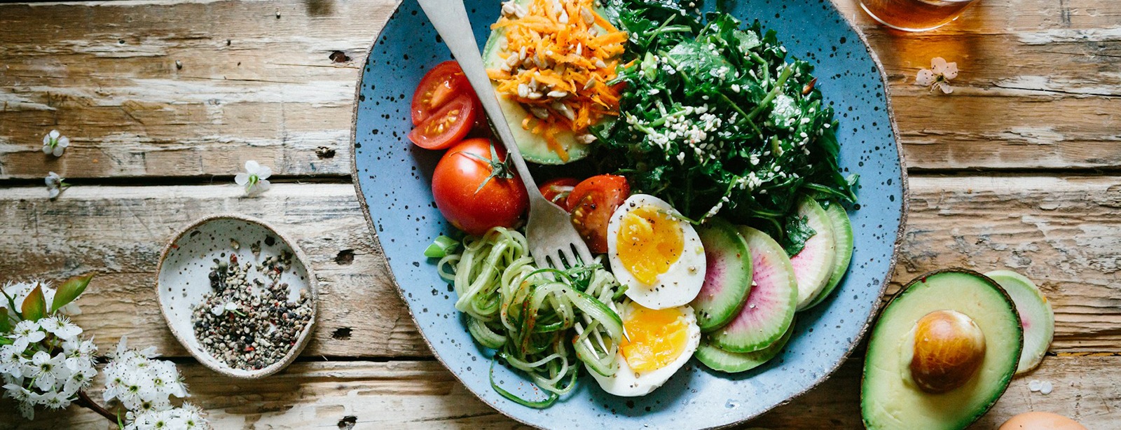 Healthy breakfast bowl with eggs, radish, and avocado.