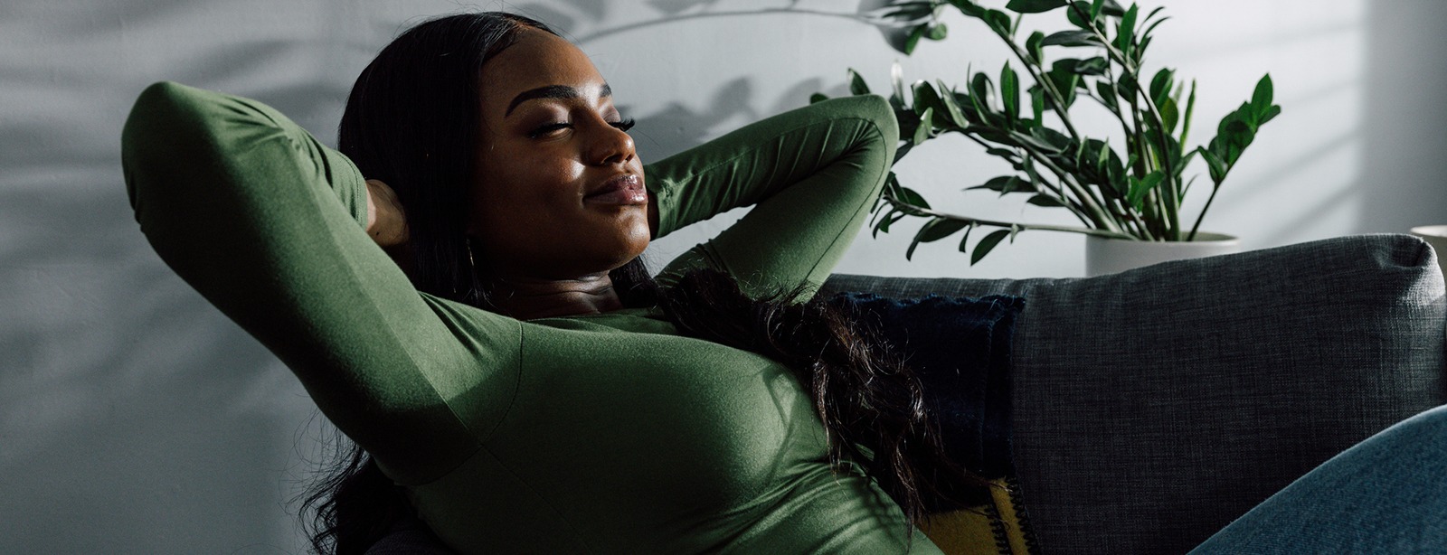 Woman relaxing comfortably on a sofa at home.