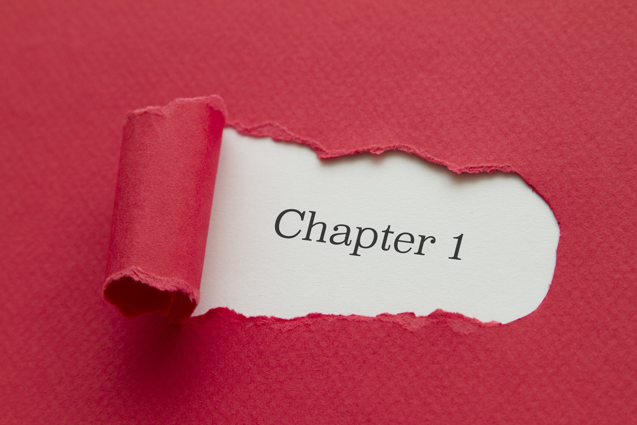 Torn red paper reveals "Chapter 1" text underneath.