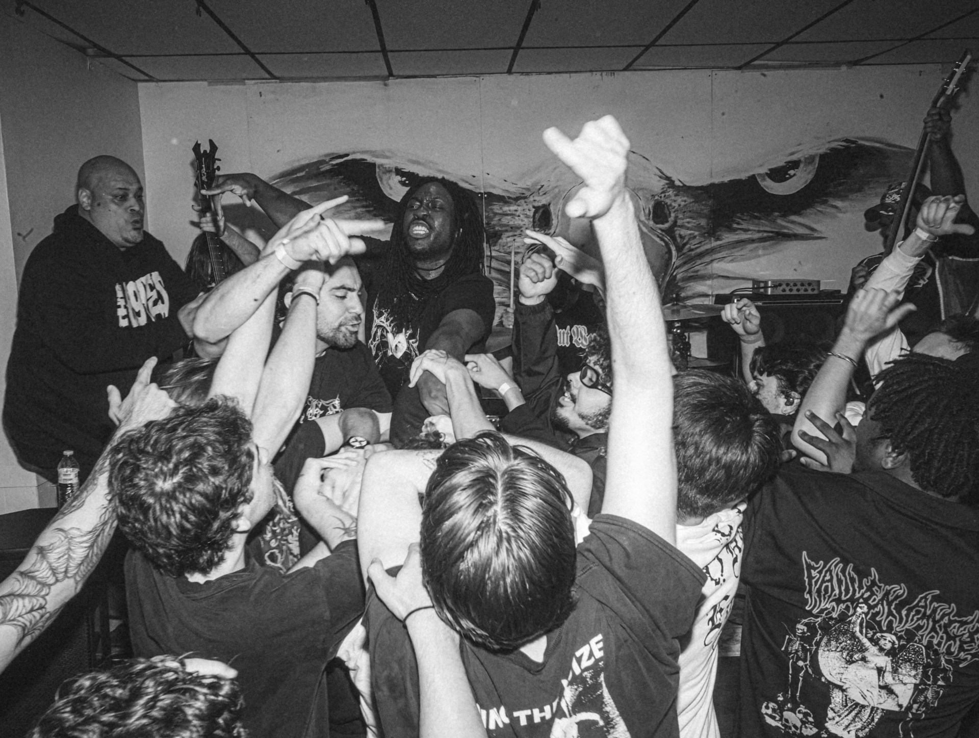 Black and white punk rock mosh pit scene.