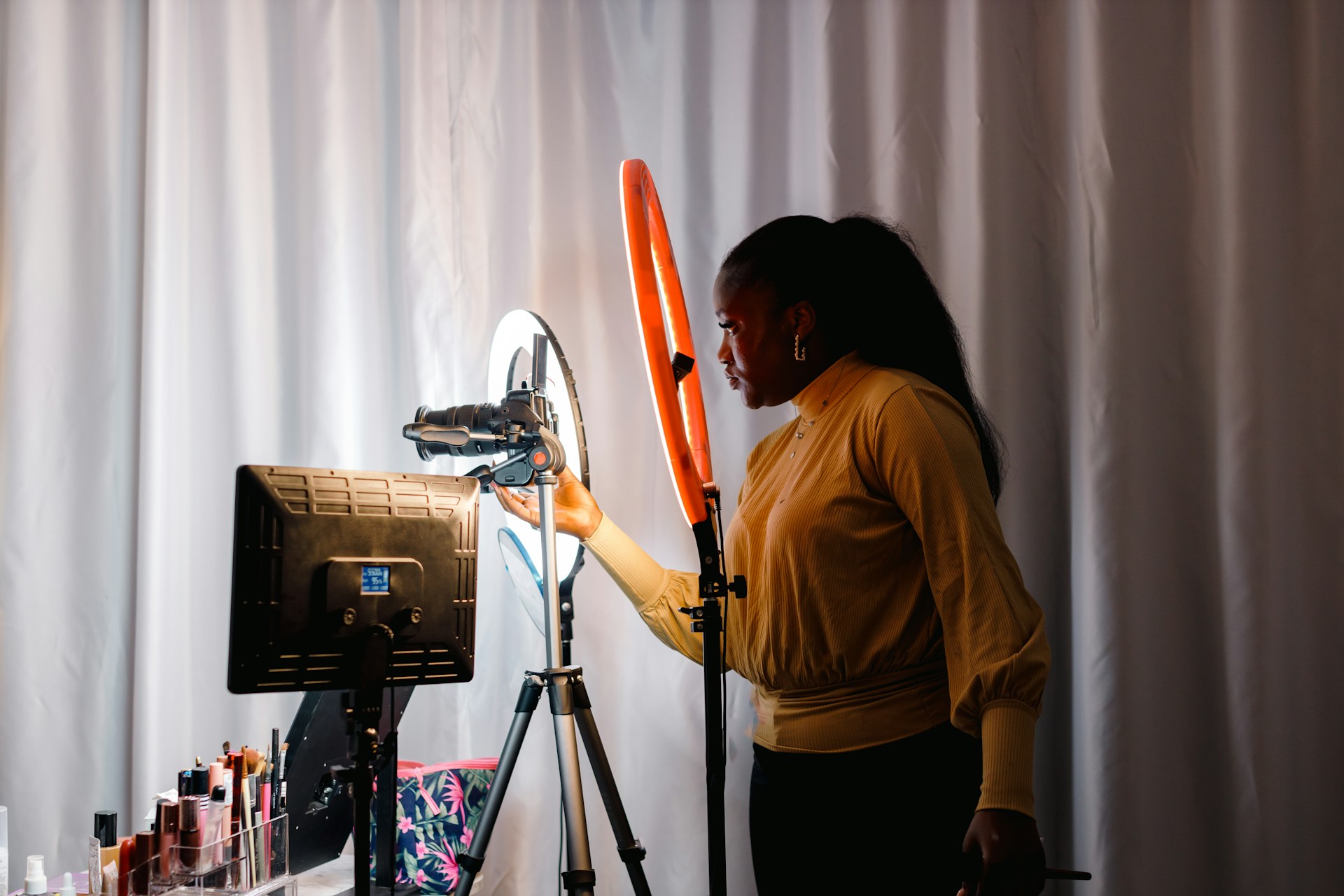 Content creator adjusting lighting and camera setup.