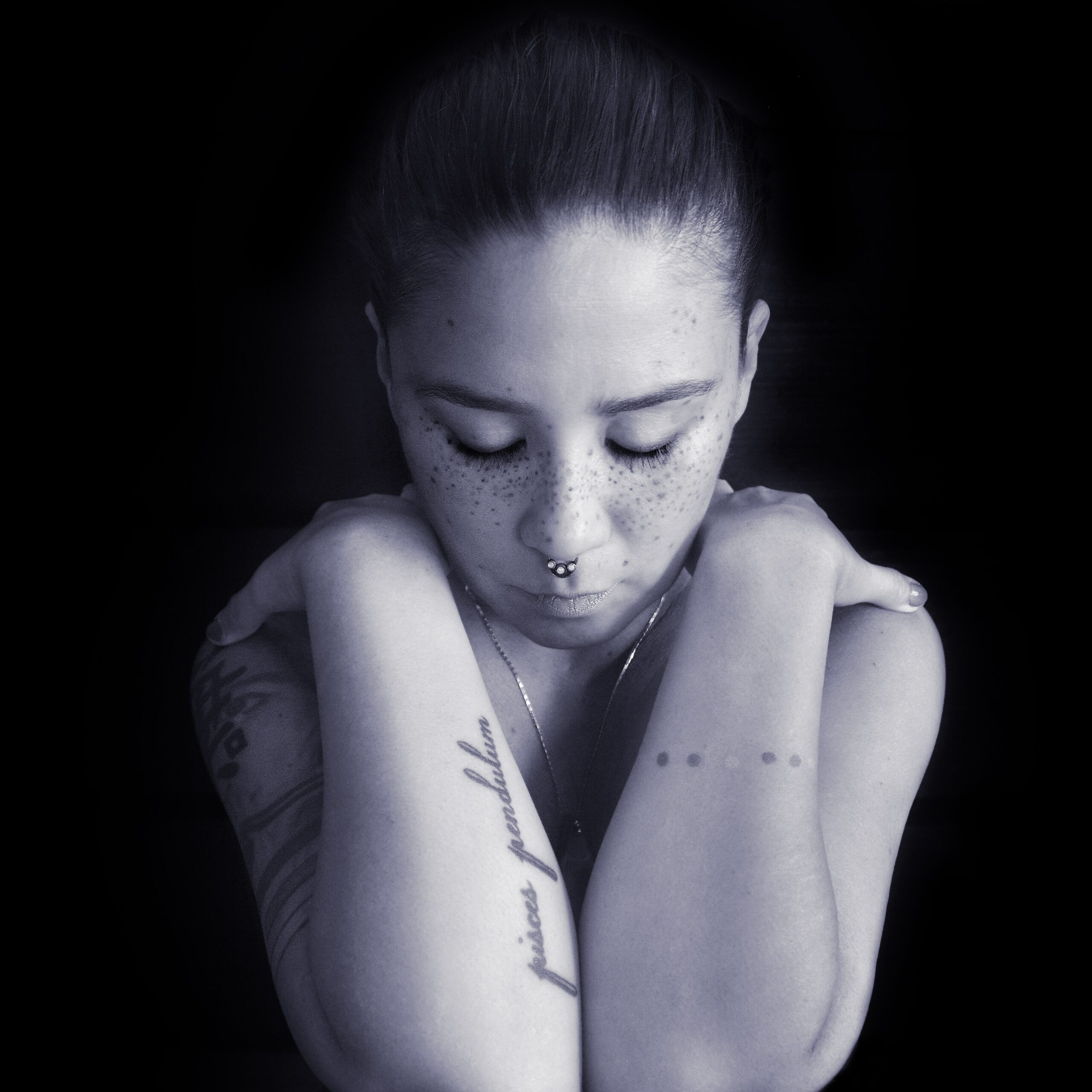 Black and white candid of a woman looking down.