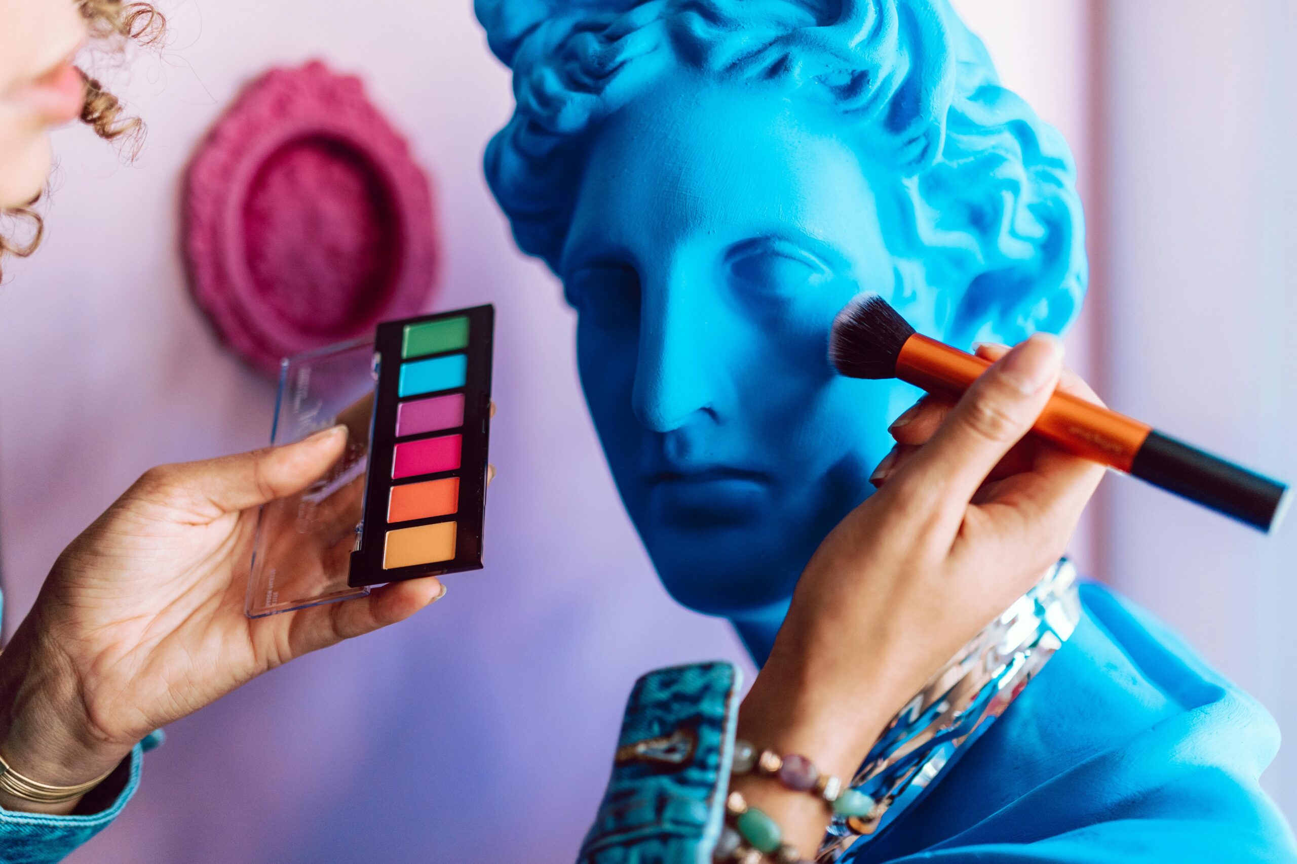 Blue statue getting makeup applied influencer style