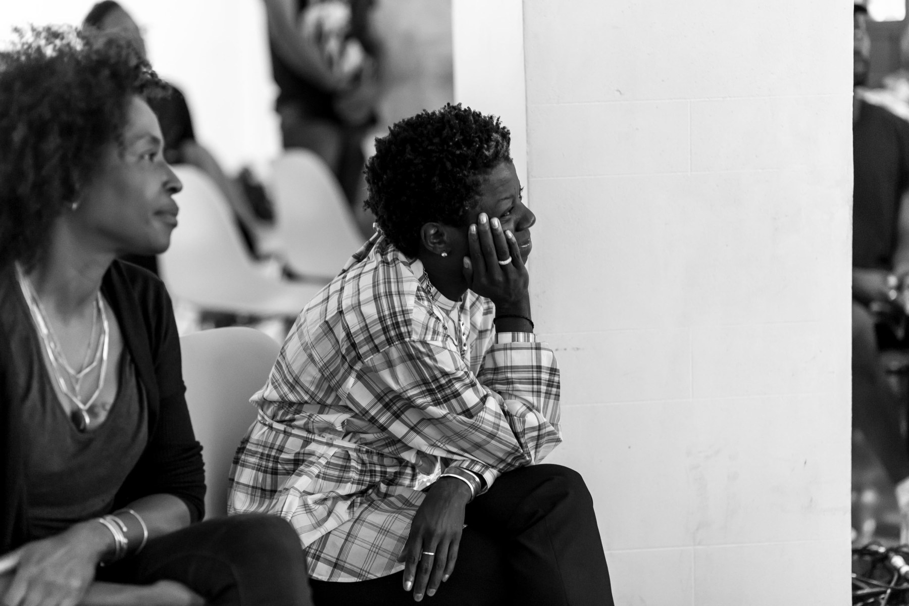 Black and white image of women listening intently.