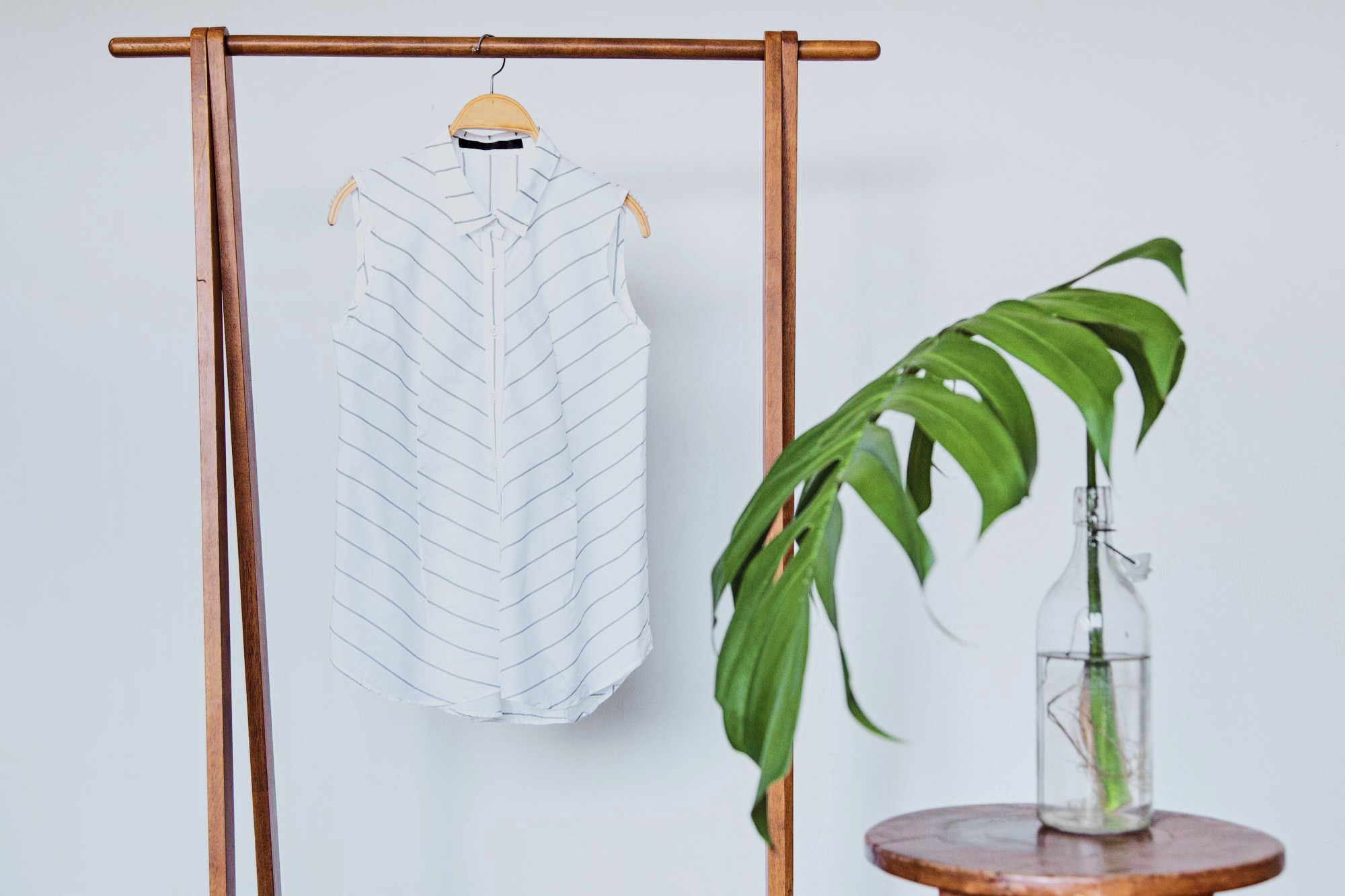 White knitted sweater with a large green leaf