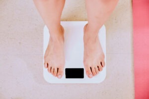 Person standing on a bathroom scale measuring weight