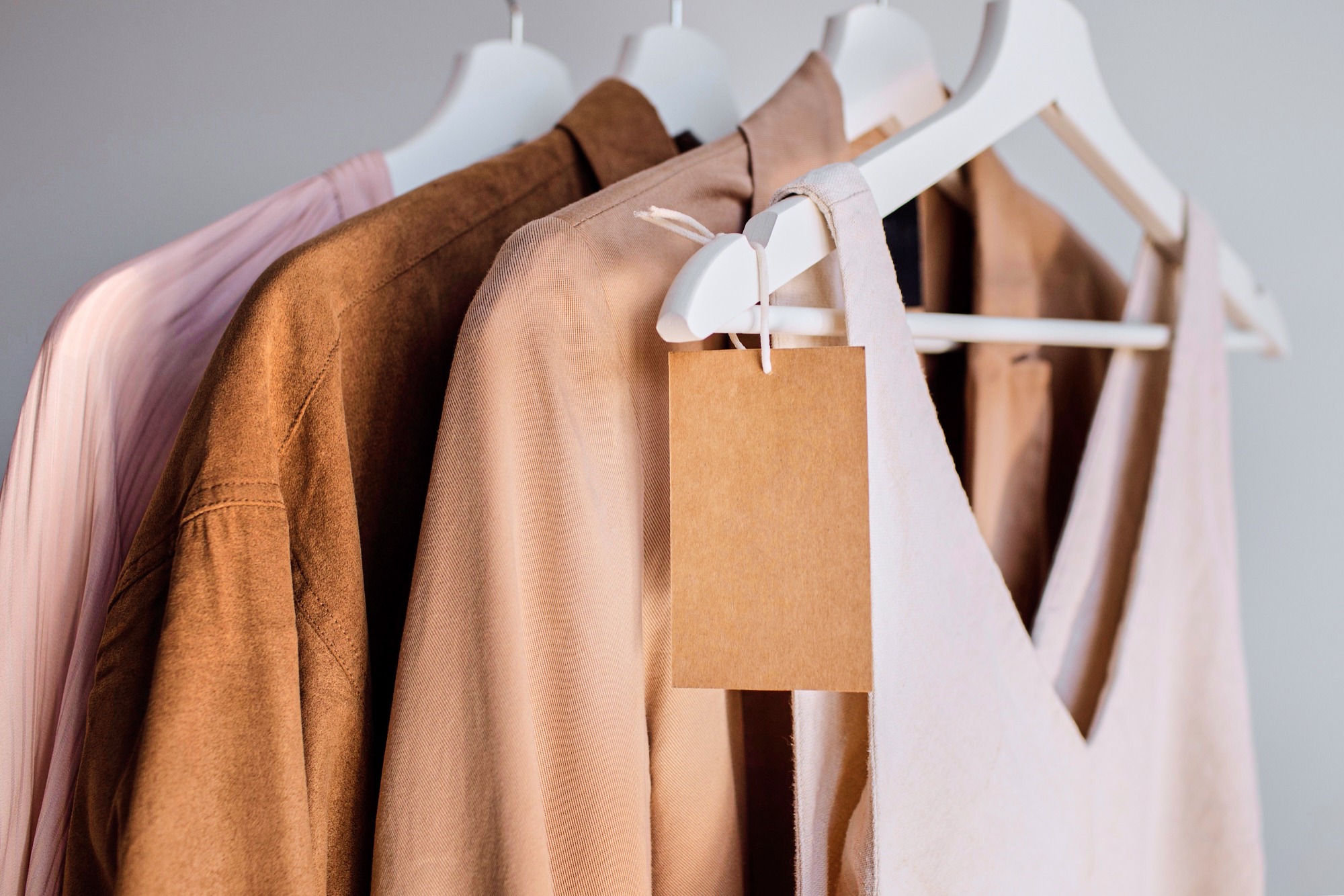 Clothes hanging on rack with blank tags