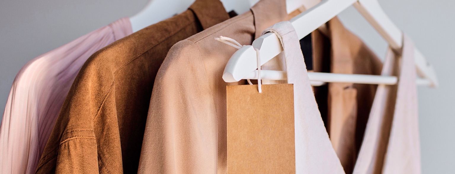 Clothes hanging on rack with blank tags