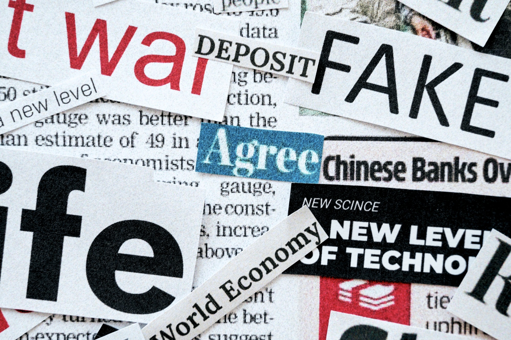 Newspaper clippings with words like FAKE war Agree