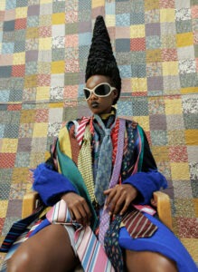 Person wearing colorful outfit and tall patterned hat