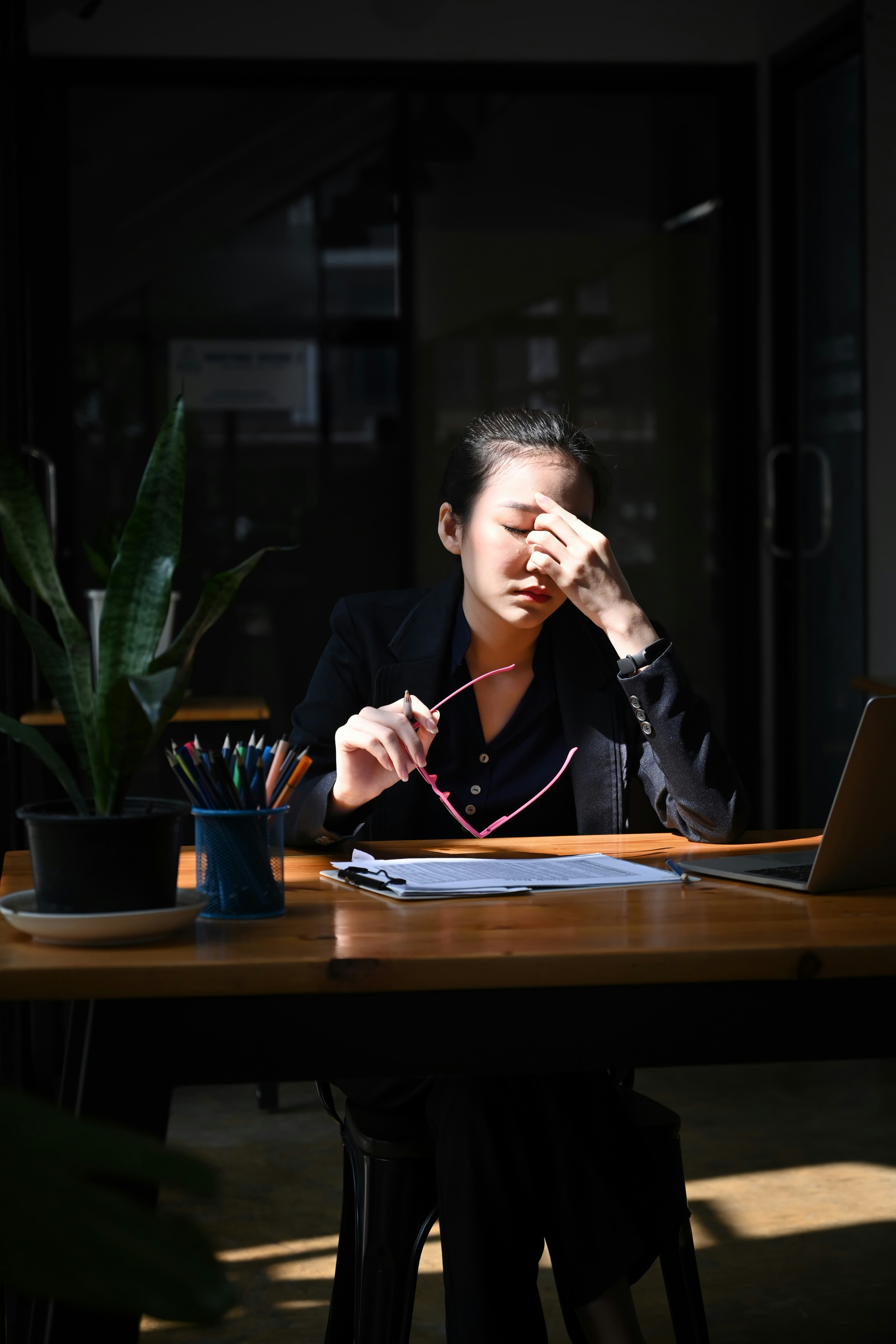 Woman looking stressed working late alone
