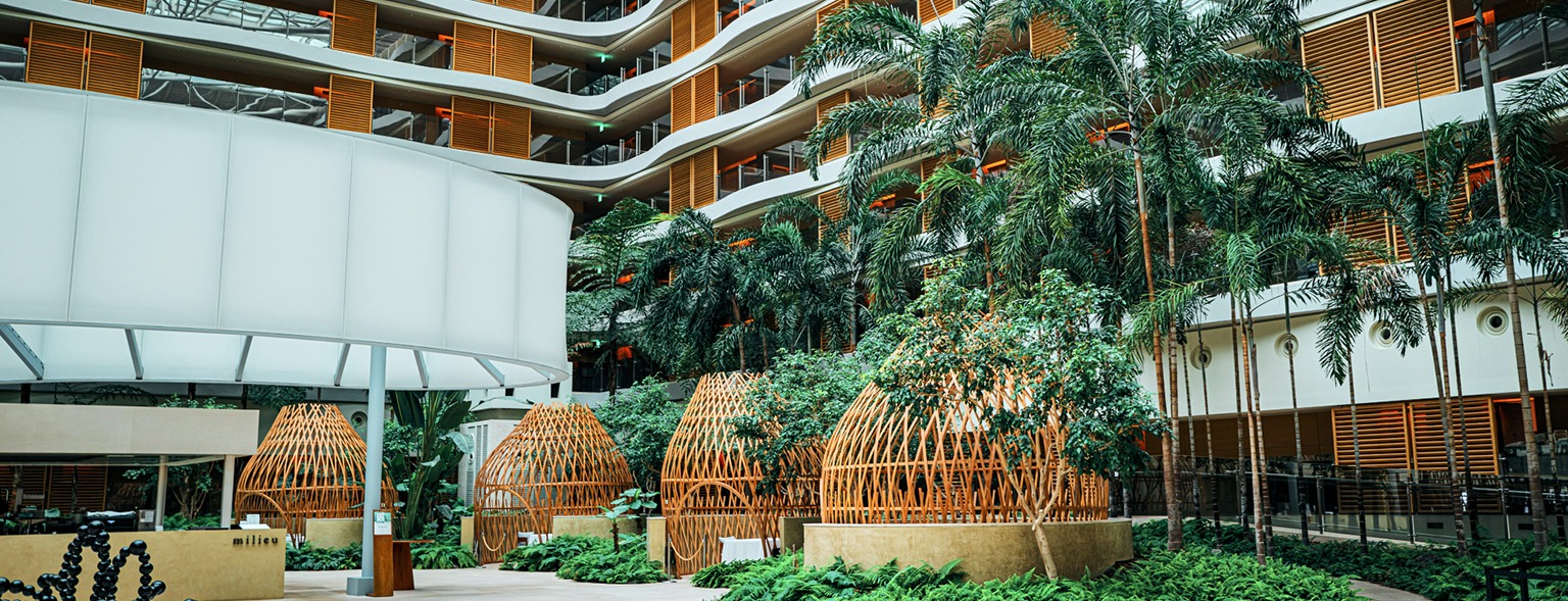 Lush green atrium of modern sustainable hotel building