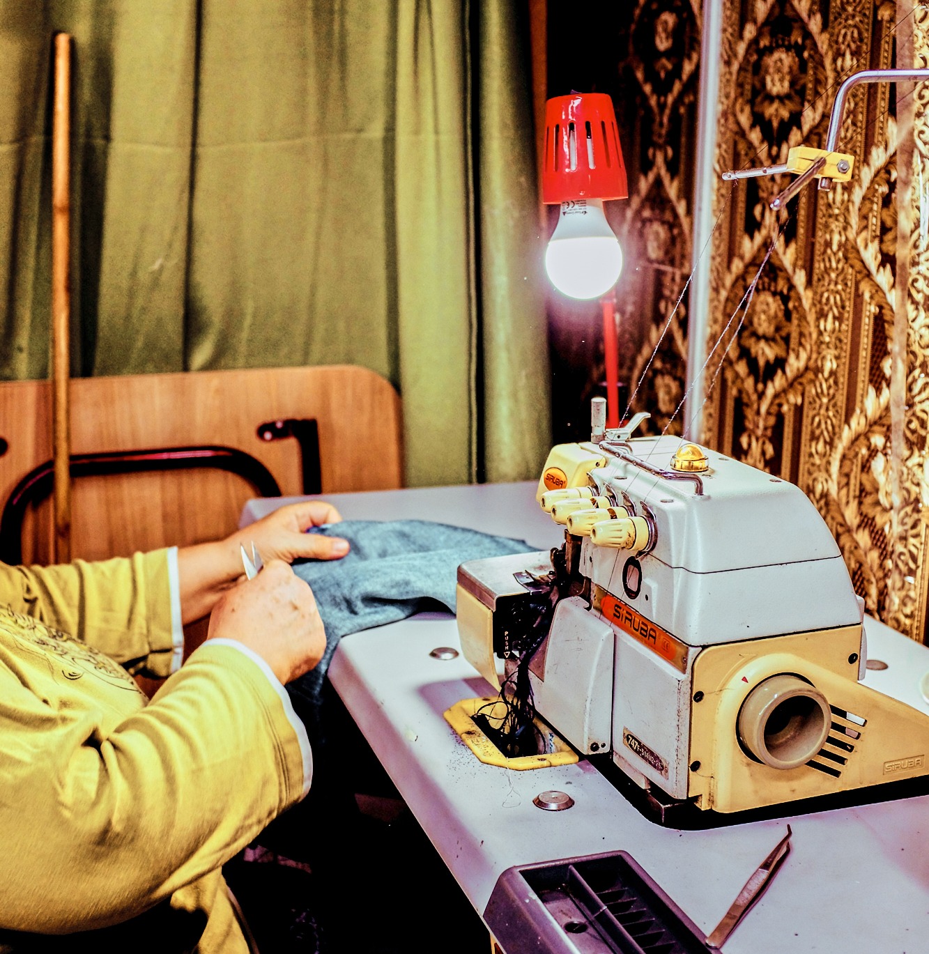 Woman sitting at table with a sewing machine