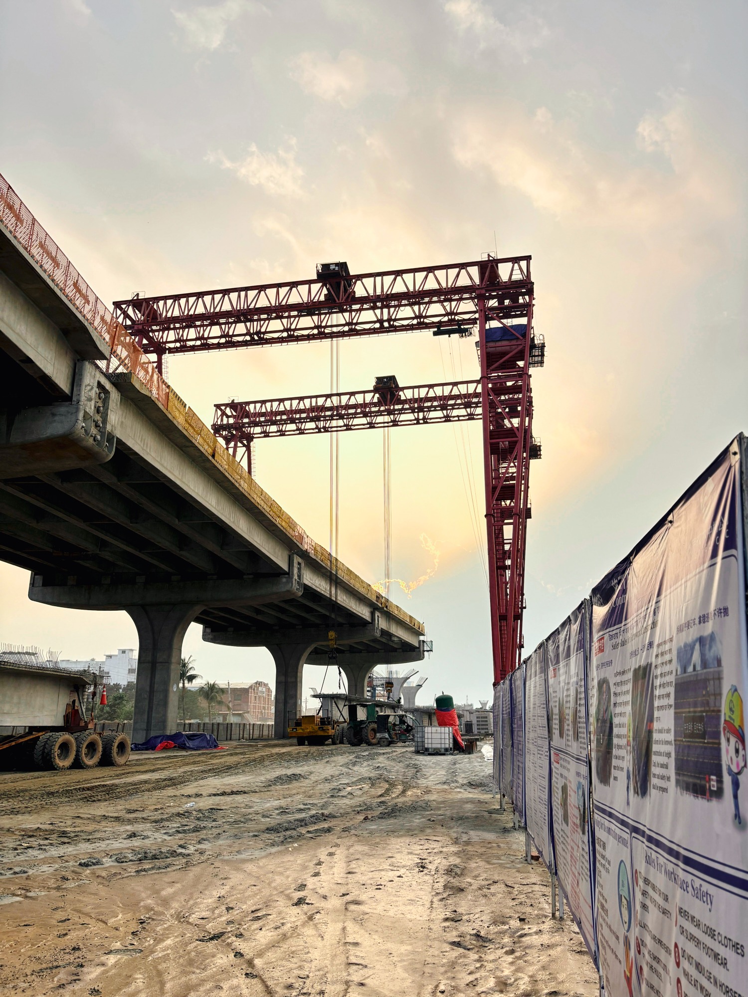 Elevated highway construction with large red crane